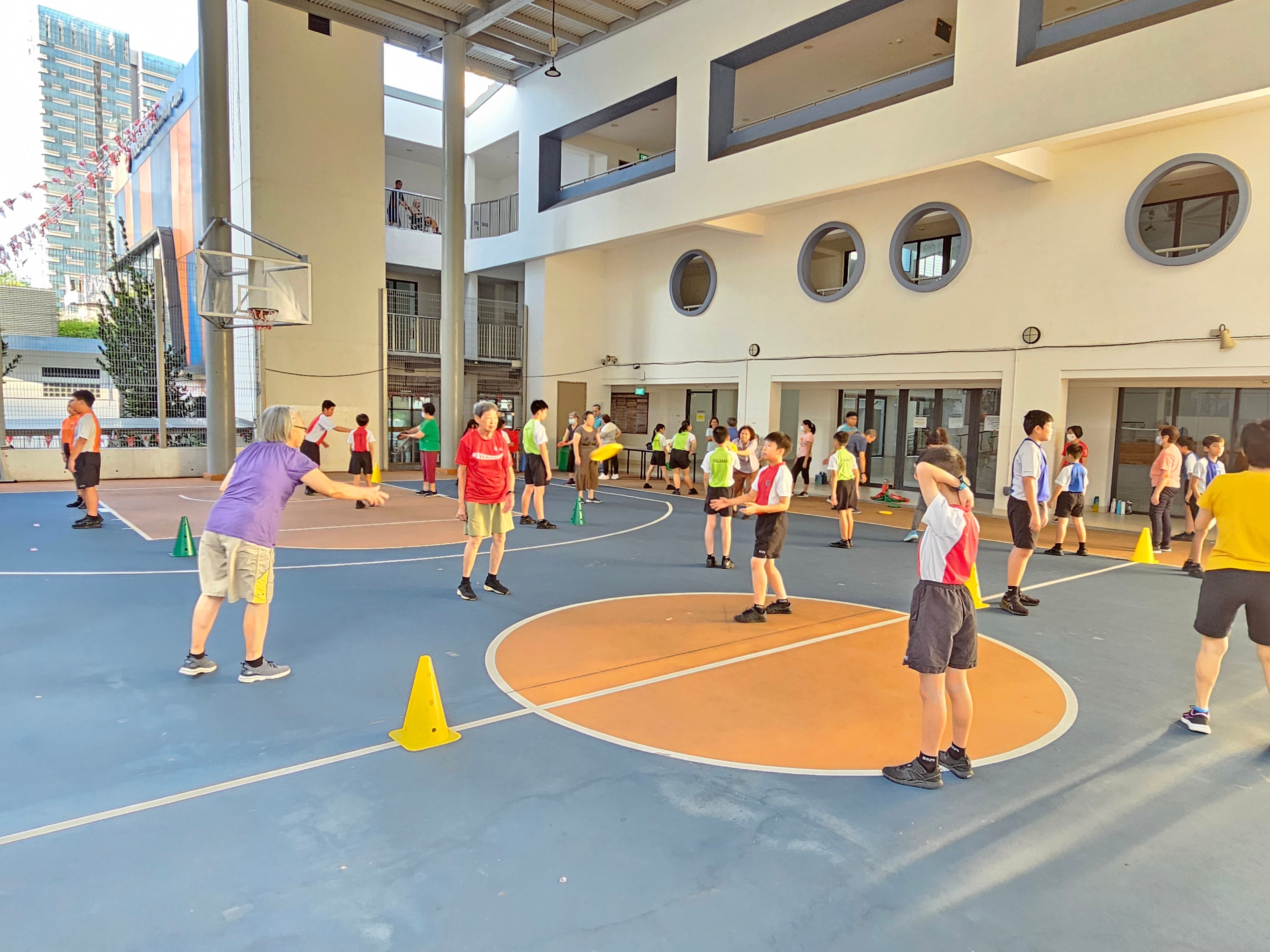 Photo of elder and youths playing sports at a sports court